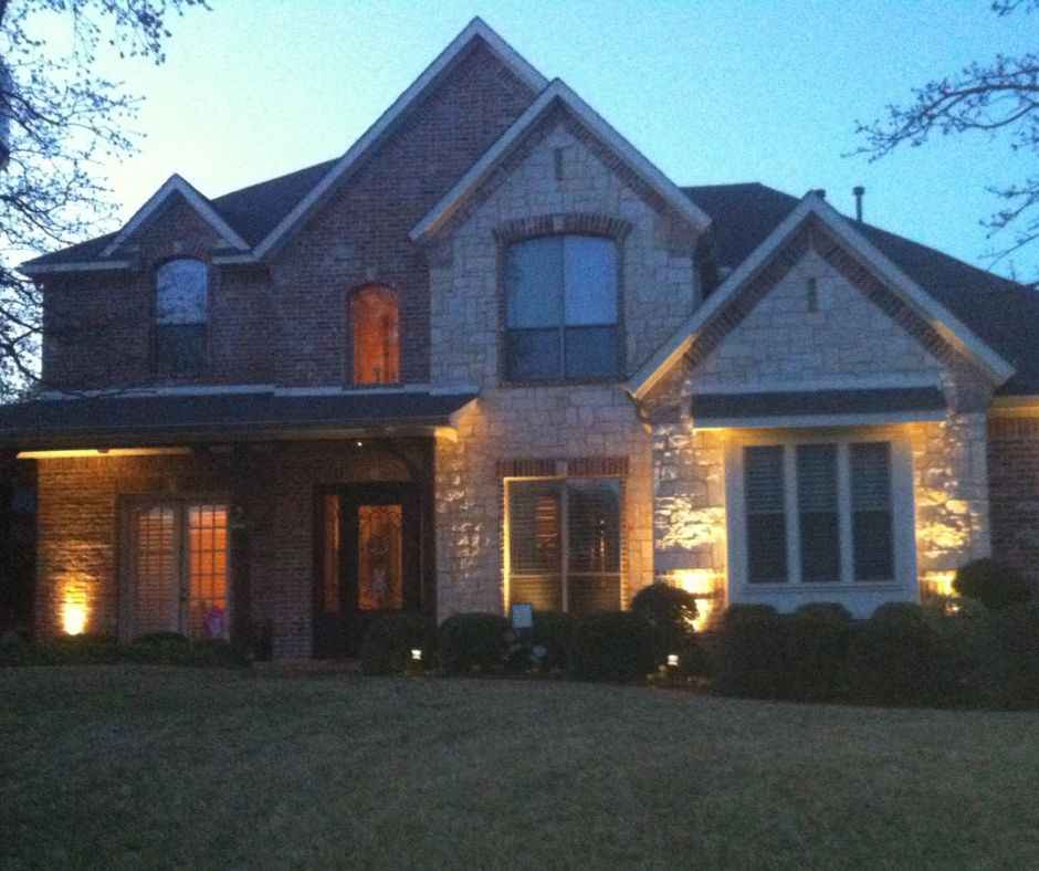 Landscape lighting being shown outside of a residential home